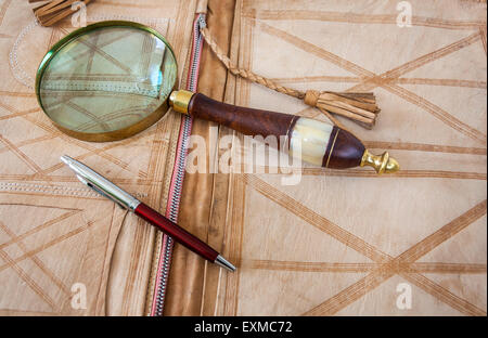 Magnifying Glass And Pen On Leather Folder Stock Photo