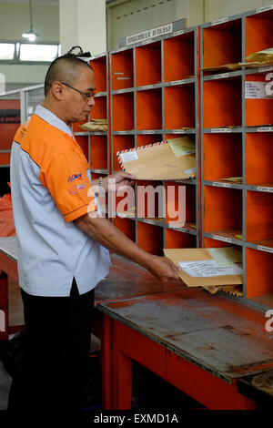 postal worker sorting mail at the main post office in malang java ...