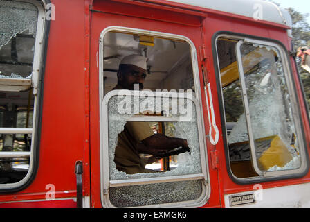 Rioters break and damage the glass pane of a BEST bus after the Dalit community resort to violent protests Mumbai Stock Photo