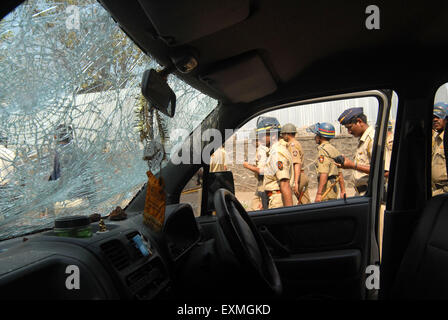 Police personnel patrolling when rioters break glass panes vehicles Bhandup Dalit community resort violent protests Mumbai Stock Photo