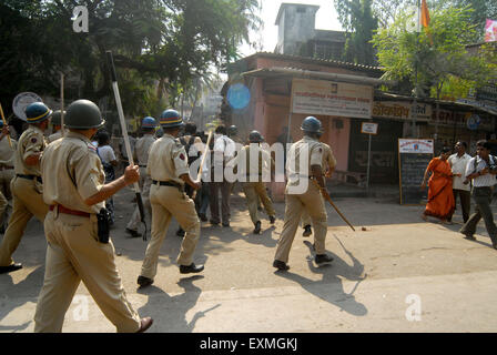 Police personnel patrolling rioters break glass panes vehicles Bhandup Dalit community resort violent protests Mumbai Stock Photo