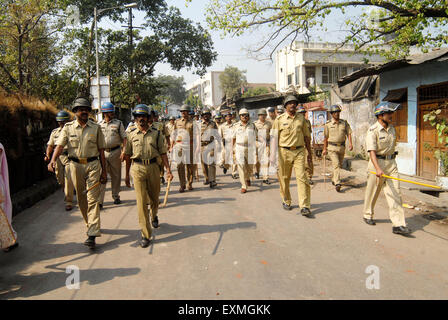 Police personnel patrolling rioters break glass panes of vehicles Bhandup Dalit community resort violent protests Mumbai Stock Photo