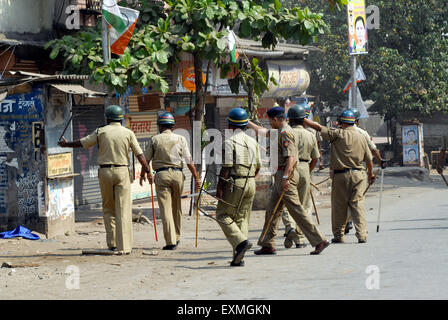 Police personnel patrolling rioters break glass panes vehicles Bhandup Dalit community resort violent protests Mumbai Stock Photo