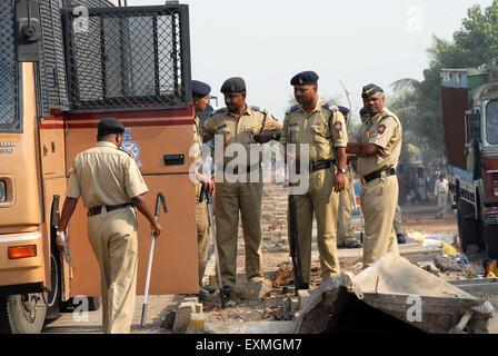 Police personnel patrolling rioters break glass panes of vehicles Bhandup Dalit community resort to violent protests Mumbai Stock Photo