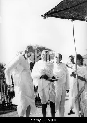 Mahatma Gandhi laughing with CF Andrews (left) Pyarelal Nayar and others at Sevagram Ashram Wardha near Nagpur Maharashtra India Asia 1939 old vintage 1900s picture Stock Photo