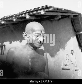 Mahatma Gandhi in front of his hut at Sevagram Ashram ; 1942 NO MR Stock Photo