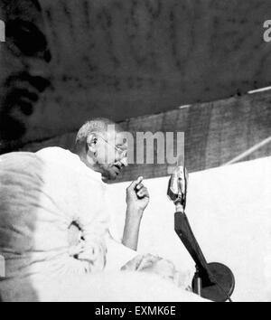 Mahatma Gandhi speaking into a mike at a mass meeting in West Bengal ...