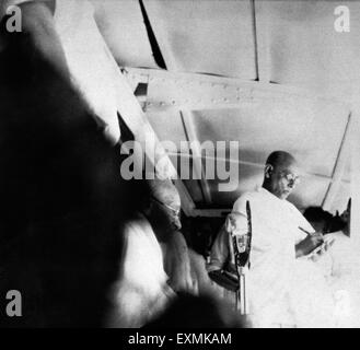 Mahatma Gandhi delivering a speech ; 1946 ; Satish Das Gupta ; his translator ; taking notes ; India NO MR Stock Photo