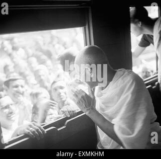 Mahatma Gandhi ; sitting in a train and interacting with people standing on the platform ; 1940 NO MR Stock Photo