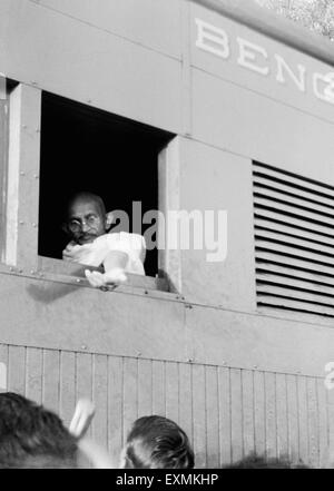 Mahatma Gandhi ; collecting donations for Harijan Fund through his window of the train ; 1941 NO MR Stock Photo