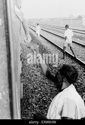 Mahatma Gandhi ; collecting donations for Harijan Fund through his window Deccan Queen Railway compartment Pune Stock Photo