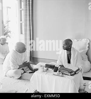 Mahatma Gandhi talking with Sardar Vallabhbhai Patel at Birla House ; Mumbai ; 1945 NO MR Stock Photo