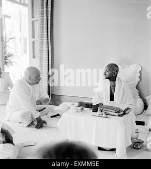 Mahatma Gandhi talking with Sardar Vallabhbhai Patel at Birla House Bombay Mumbai India 1945 Stock Photo