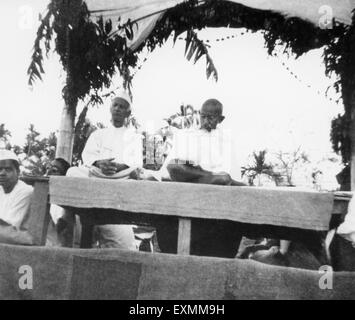 Thakkar Bapa and Mahatma Gandhi at a prayer meeting in the riot stricken areas of Noakhali ; East Bengal Stock Photo