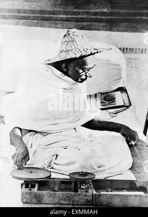 Mahatma Gandhi wearing Noakhali hat spinning Birla House Delhi  india November 1947 Stock Photo