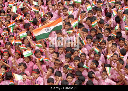 School children celebrating Indian Independence Day by waving Indian flag in Bombay Mumbai Maharashtra India Stock Photo