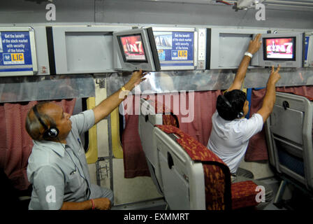 Passenger watching television introduce by Indian Railways on experimental basis in one of air conditioned bogie Mumbai Stock Photo