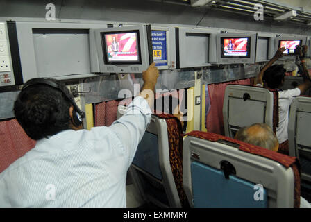 Passenger watching television introduce by Indian Railways on experimental basis in one of air conditioned bogie Mumbai Stock Photo