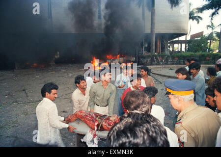 Helping victim terror bomb blast 1993 Bombay Mumbai Maharashtra India 1900 1900s Mumbai attack Mumbai terror 1993 Bombay bombings 12 March 1993 Stock Photo