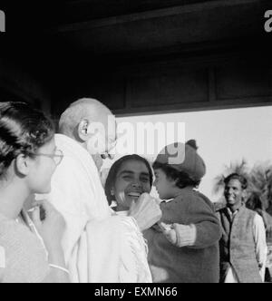 Abha Gandhi ; Mahatma Gandhi and Sushila Nayar carrying Rajiv Gandhi at Shantiniketan ; 1945 ; India NO MR Stock Photo