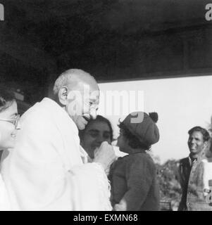 Abha Gandhi ; Mahatma Gandhi and Sushila Nayar carrying Rajiv Gandhi at Shantiniketan ; 1945 ; India NO MR Stock Photo