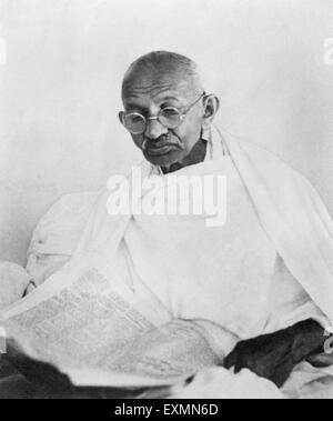 Mahatma Gandhi reading newspaper ; 1940 ; India NO MR Stock Photo
