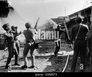 police officer firing tear gas shell control riots mumbai Maharashtra India Stock Photo