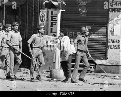 police catching man control riots mumbai Maharashtra India Stock Photo