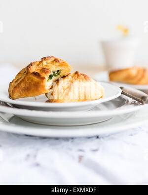 homemade puff pastry filled with wild garlic / spinach and sour cream. Selective focus. Stock Photo