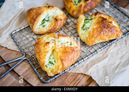 homemade puff pastry filled with wild garlic / spinach and sour cream. Selective focus. Stock Photo