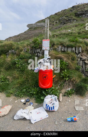 Coastal path, Cornwall. Rubbish overflowing bin. Stock Photo