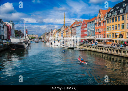 Nyhavn, a 17th century waterfront in Copenhagen, in a sunny day with 18th century townhouses and bars, cafes and restaurants. Stock Photo