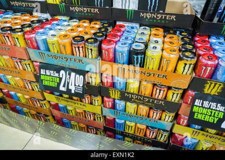 A display of Monster energy drinks cans on the shelves of a grocery ...