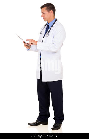 side view of young medical doctor using tablet computer isolated on white background Stock Photo
