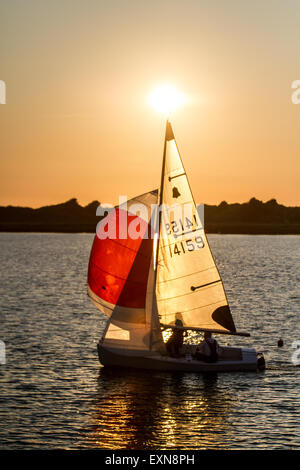 GP 14-foot dinghy raced, cruised, rowed in Merseyside, UK. Dusk looms for competitors in the Southport 24 Hour Race. A national sailing endurance race for two-handed sailing dinghies, with up to 70 Firefly, Lark, Enterprise and GP 14 boat crews competing. The exhausting race, which is hosted by the West Lancs Yacht Club starts at 12 noon on the Saturday with the contestants racing their dinghies non-stop, around the resorts marine lake finishing at noon 24 hours later. Sailing skills and endurance are put to a severe test during the 12 hours of darkness. Stock Photo