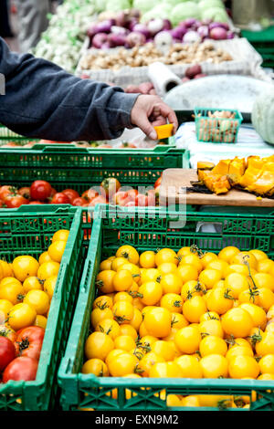 Picking a sample at produce stall, Farmers' Market, Railyard District, Santa Fe, New Mexico USA Stock Photo