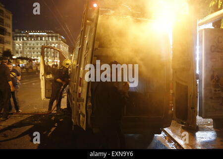 Athens, Greece. 15th July 2015. An outside broadcasting van from Greek TV station Antenna (ANT1) has been set on fire during the anti-austerity protest in Athens. Molotov cocktails, tear gas and stun grandees were thrown by protesters and police when an anti-austerity protest outside the Greek parliament turned violent. The protea was hold while the Greek parliament was voting on new austerity measures. Credit:  Michael Debets/Alamy Live News Stock Photo