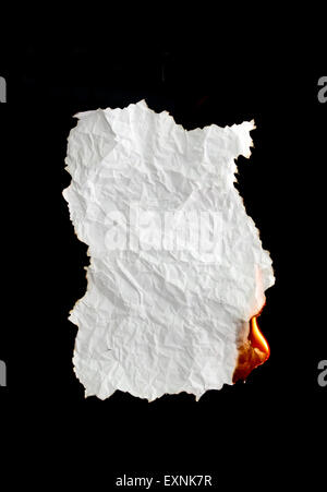 white crumpled  paper burning on black background Stock Photo