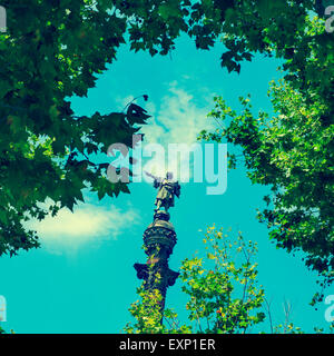 a view of the Columbus Monument in Barcelona, Spain, between some trees, with a retro effect Stock Photo