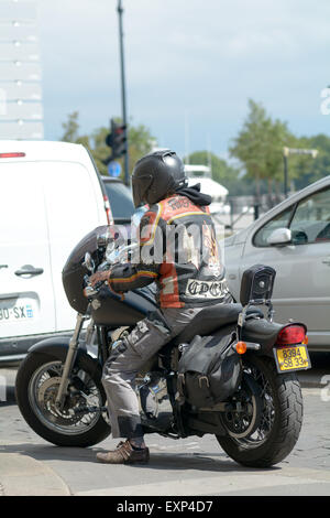 Man riding Harley Davidson motorbike with amazing leather jacket design in Bordeaux France Stock Photo