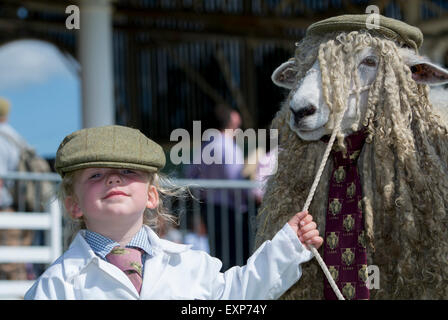 Yorkshire, UK. 15th July, 2015. 3 year old Loveday Durham from Leyburn in Wensleydale, North Yorkshire, took the prize at the Great Yorkshire Show for the best dressed sheep with her parents Lincoln Longwool sheep. Credit:  Wayne HUTCHINSON/Alamy Live News