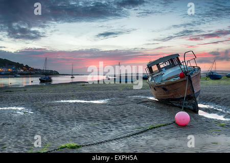 Stunning sunset over boats on the beach at Instow just outside of Bideford on the north coast of Devon, with the fishing village Stock Photo