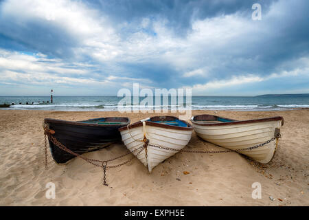 Fishing boats on the beach at Durley Chine, part of Bournemouth beach in Dorset Stock Photo
