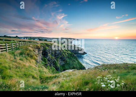 Sunset on the north Cornwall coast looking out to Port Gaverne and Port Isaac Stock Photo