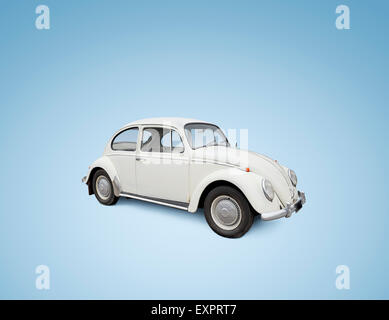 Vintage Volkswagen Beetle car isolated on blue background. Please not: the car is NOT in perfect condition. Stock Photo