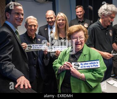 U.S. Senator Barbara Mikulski holds a bumper sticker given to her by members of the New Horizons team at the Johns Hopkins University Applied Physics Laboratory July 13, 2015 in Laurel, Maryland. Joining her are: (L-R) APL Director Ralph Semmel, New Horizons Principal Investigator Alan Stern SwRI, Associate Administrator for the Science Mission Directorate John Grunsfeld and NASA Deputy Administrator Dava Newman. Stock Photo