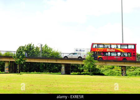 A double decker red park and ride bus drives on a curved road near the centre of Bristol. Stock Photo