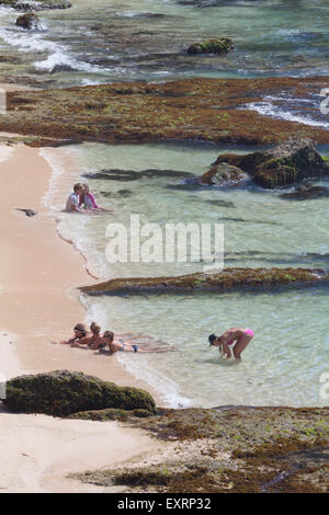 Tourists having recreational time on Padang-padang beach in Labuan Sait, South Kuta, Badung, Bali, Indonesia. Stock Photo