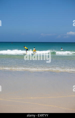 St Ives, Cornwall, UK:  Group of people learning to Surf off Porthmeor Beach at St Ives in Cornwall. Stock Photo
