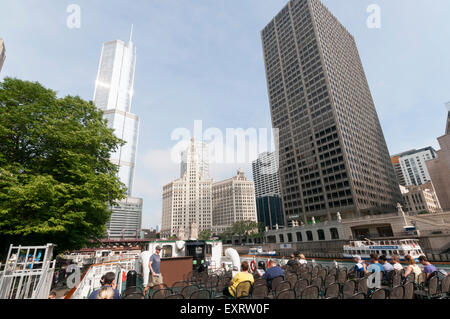 Tourists aboard a Chicago Architecture Foundation river cruise with the Trump Tower and Wrigley Building in background. Stock Photo